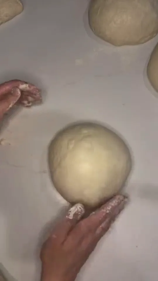 Goldenrod's baker shaping sourdough by hand at a flour-dusted worktop